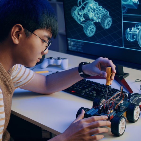 A kid repairing a wireless toy car